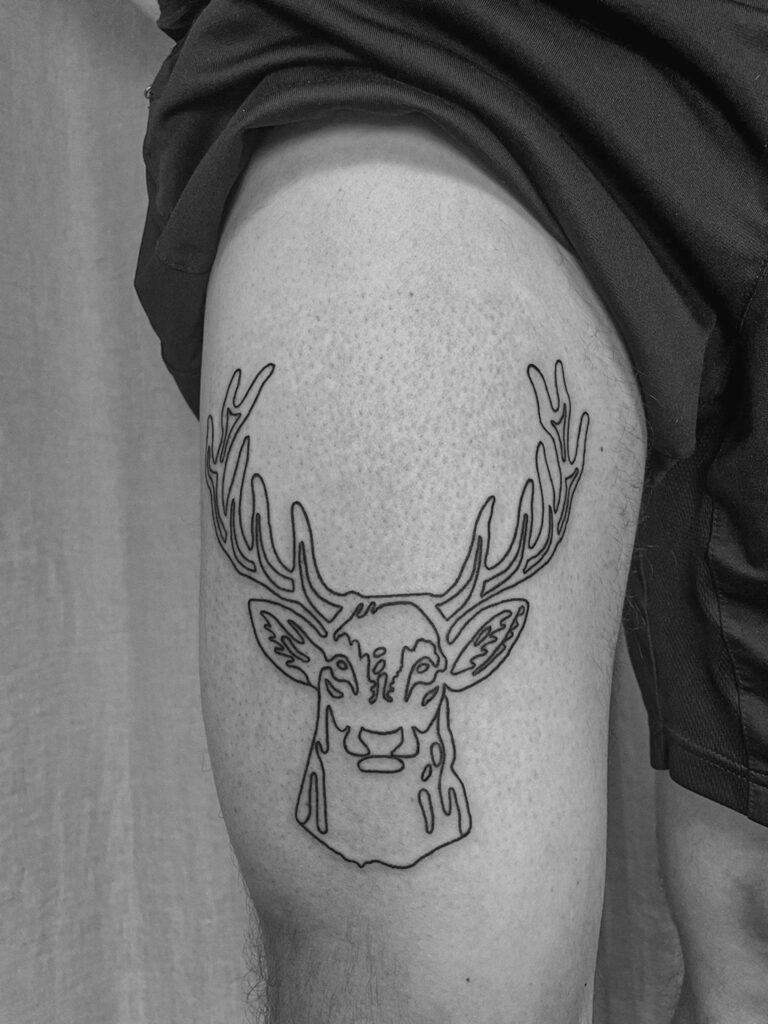 Hirschkopf-Tattoo auf einem Oberschenkel, gestaltet von Apprentice Tattoo-Künstlerin Lea.